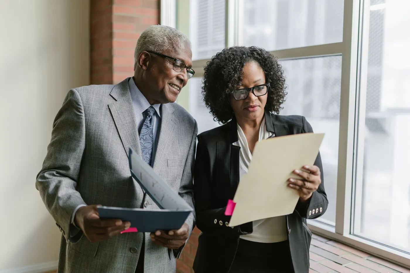 Two financial advisers reviewing a client's plan together